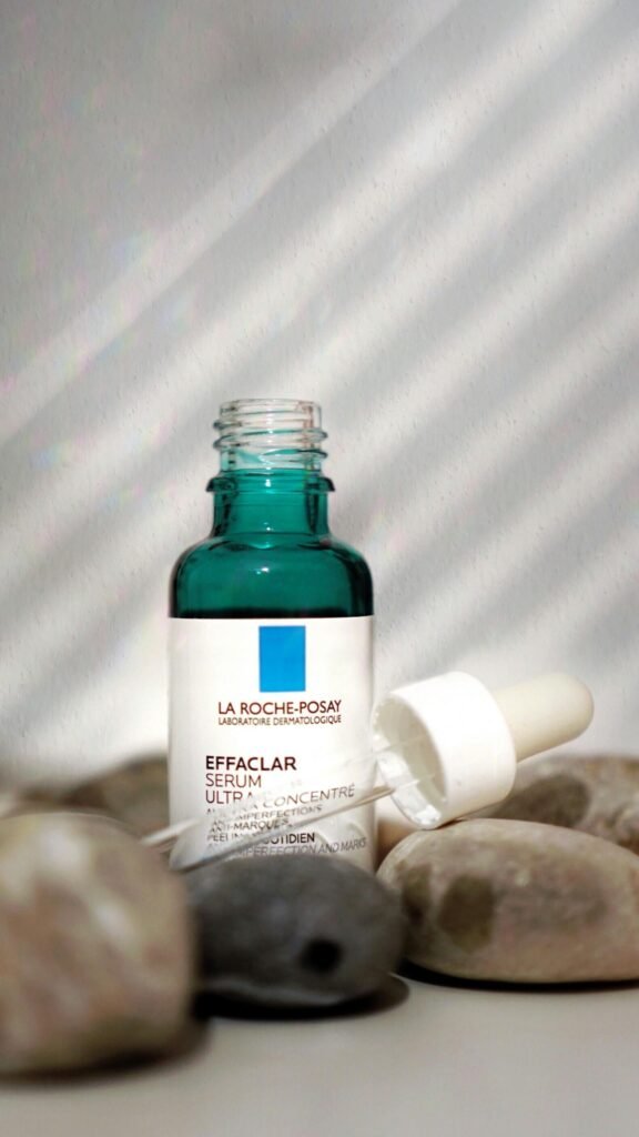 La Roche-Posay serum bottle on stones with shadows. Perfect for skincare ads.
